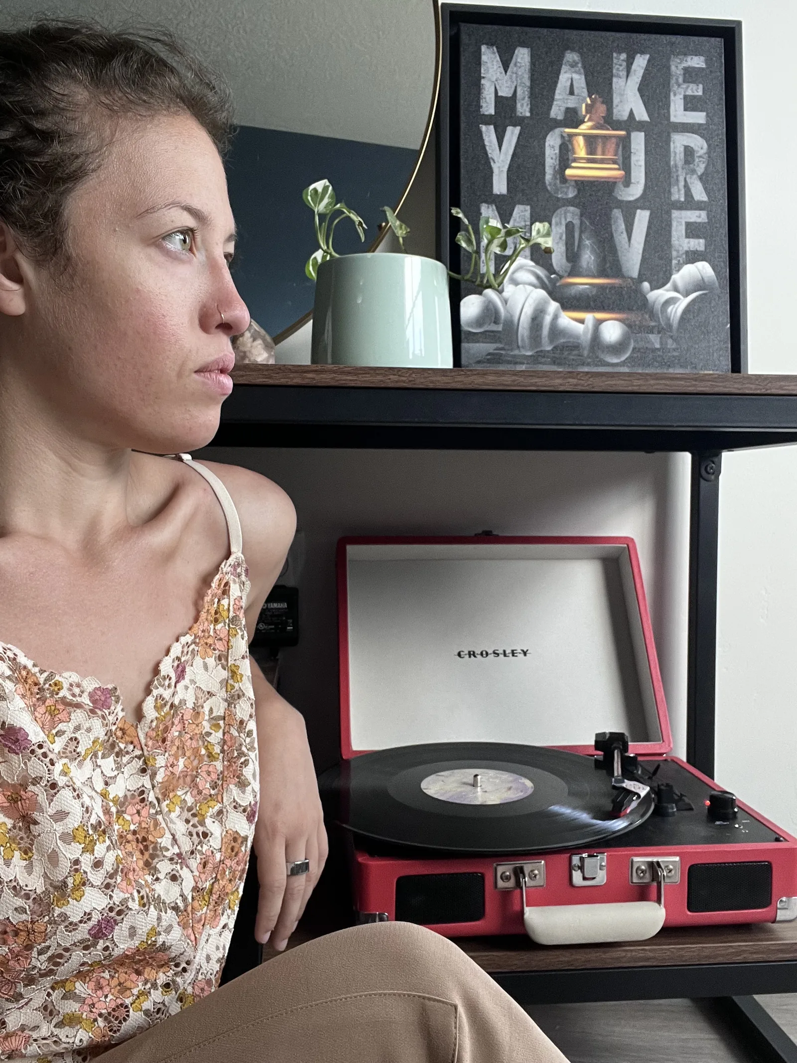 Destiny Cabrales looking to the right beside a record player