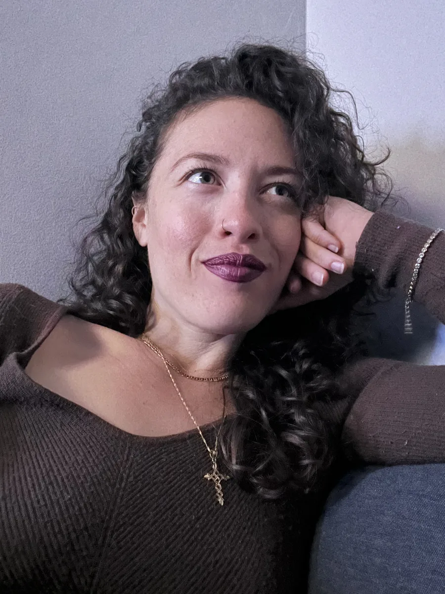 Destiny Cabrales reclining at home with a thoughtful expression